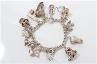 Lot 3266 - Silver charm bracelet with quantity of silver...