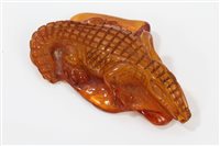 Lot 954 - Antique carved amber crocodile figure, 7cm