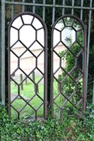 Lot 1446 - Pair of cast iron mirrored panels of arched...