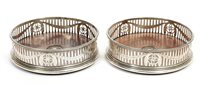 Lot 273 - Pair George III silver wine coasters of...