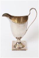 Lot 284 - George III silver helmet-shaped cream jug with...