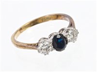 Lot 428 - Sapphire and diamond three stone ring with a...