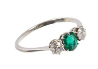 Lot 433 - Emerald and diamond three stone ring with an...