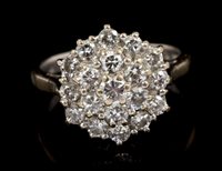 Lot 466 - Diamond cluster ring with a circular cluster...