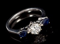 Lot 467 - Diamond and sapphire three stone ring with a...