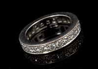 Lot 471 - Diamond eternity ring with a full band of...