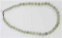 Lot 548 - Chinese green hardstone bead necklace with a...