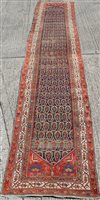 Lot 1450 - Old Persian runner with repeating floral...