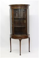 Lot 1332 - Early 20th century walnut bow front display...