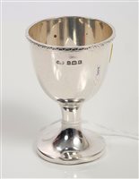 Lot 204 - 1920s silver egg cup of conventional form,...