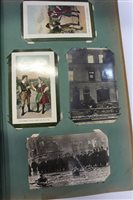 Lot 2411 - Postcards in two albums - including four real...