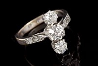 Lot 517 - 1920s diamond three stone ring with three old...