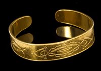 Lot 520 - Eastern yellow metal torque bangle with...