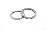 Lot 526 - Two diamond full band eternity rings, one with...