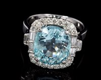 Lot 532 - Aquamarine and diamond cluster ring, the oval...