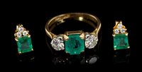 Lot 540 - Emerald and diamond three-stone ring with a...