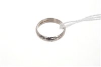 Lot 547 - Platinum wedding ring with engraved design...