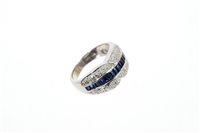 Lot 577 - Sapphire and diamond ring with a central band...