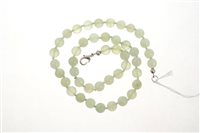 Lot 596 - Chinese green hardstone bead necklace with a...