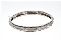 Lot 597 - Indian white metal and diamond hinged bangle...