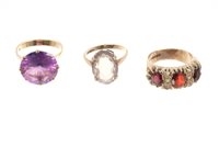 Lot 501 - Three gold and gem set dress rings - various