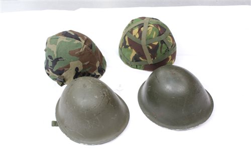 Lot 723 - Two military tin helmets - one stamped - 1958,...