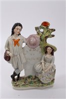 Lot 137 - Victorian Staffordshire figure group of a dog...