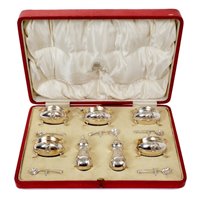 Lot 267 - George V silver seven piece cruet set -...