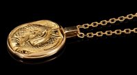 Lot 445 - Cartier 18ct gold Zodiac pendant necklace, the...
