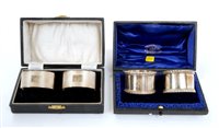 Lot 191 - Two pairs silver napkin rings in cases
