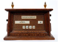 Lot 800 - Early 20th century oak desk calendar,...