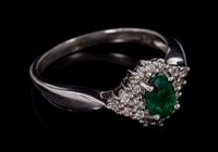 Lot 481 - Emerald and diamond cluster ring with an oval...