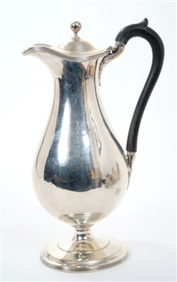 Lot 440 - George III silver hot water jug of baluster form, with ebony loop handle, hinged domed cover with ball finial on a circular pedestal base (London 1795), Henry Chawner