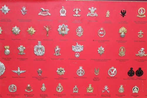 Lot 579 - Collection of 80 British Military Stay Brite cap badges mounted on board