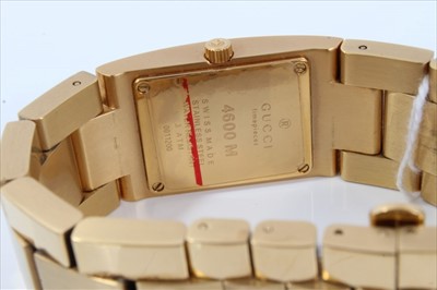 Lot 60 - Gucci gilt stainless steel wristwatch with rectangular white dial, numbered 0011200, boxed