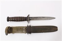 Lot 811 - Second World War American M3 Fighting Knife with ribbed wooden grip and steel blade stamped 'US M3 Camillus' in its fibre scabbard with webbing frog.