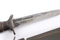 Lot 811 - Second World War American M3 Fighting Knife with ribbed wooden grip and steel blade stamped 'US M3 Camillus' in its fibre scabbard with webbing frog.