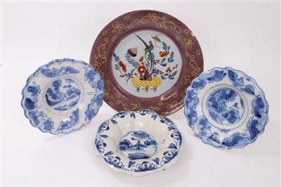 Lot 242 - 18th century Delft polychrome charger, 30cm and three Delft dishes, 21-23cm