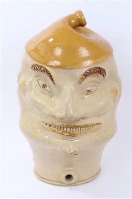 Lot 308 - Large 19th century novelty stoneware flagon in the form of a grinning male head, 53cm