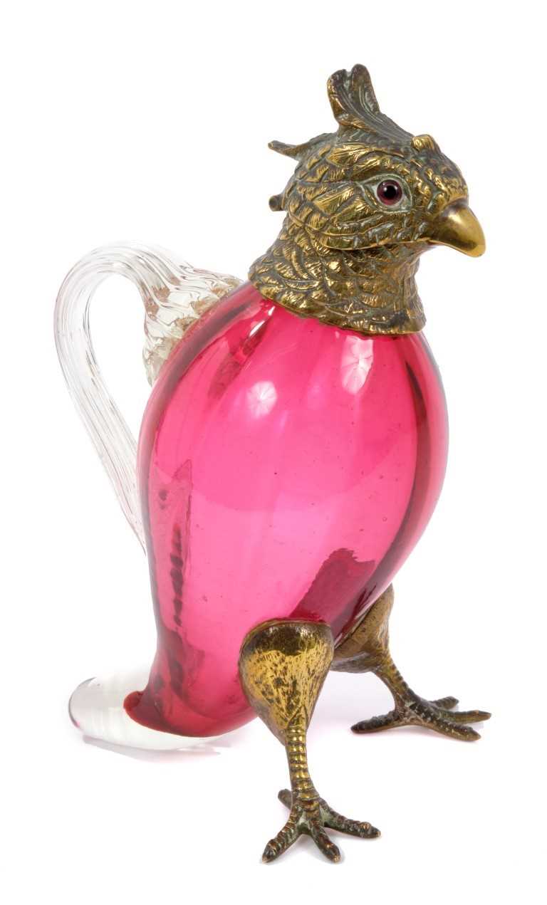 Lot 905 - Victorian cranberry glass spirit/oil decanter in the form of bird with brass mounts