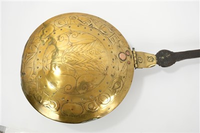 Lot 944 - 17th century brass and iron warming pan, tulip ornament and embossed motto ‘God grant grace’