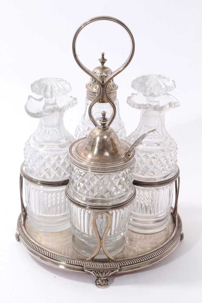 Lot 377 - George III silver cruet frame with four