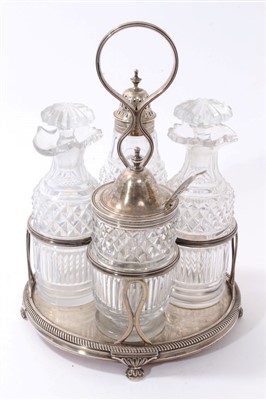 Lot 377 - George III silver cruet frame with four lidded cut glass condiment bottles, William Bateman 1819