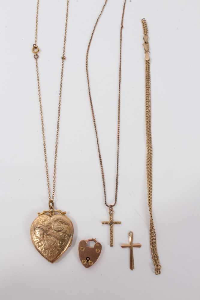 Lot 3234 - Group gold (9ct) jewellery including two cross pendants, chain, bracelet, padlock claps and a heart shaped locket on yellow metal chain