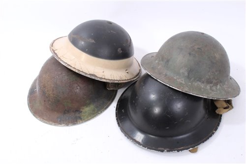 Lot 600 - Group of four Second World War British Military MKII Steel Helmets to include Home Front Ambulance Driver and Camouflaged Helmet dated 1939 (4)