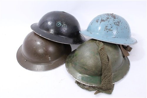 Lot 601 - Group of four Second World War British Military MKII Steel Helmets to include Home Front / Civil Defence and Camouflaged Helmet dated 1939 (4)