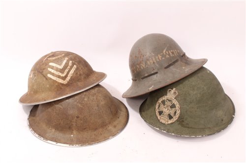 Lot 602 - Two Second World War British Military MKII Steel Helmets together with a 1941 A.R.P Helmet a British MKIV Steel helmet with Royal Green Jackets Badge (4)