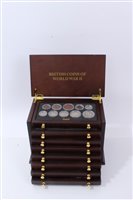 Lot 122 - G.B. a teak eight-drawer cabinet containing ‘British Coins of World War II’ 1939 – 1945, with Certificates of Authenticity (qty)