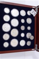 Lot 126 - U.S. a teak one-drawer cabinet with glass hinged top, containing ‘A Century of U.S. Silver Coin Collection’, with Certificates of Authenticity (qty)