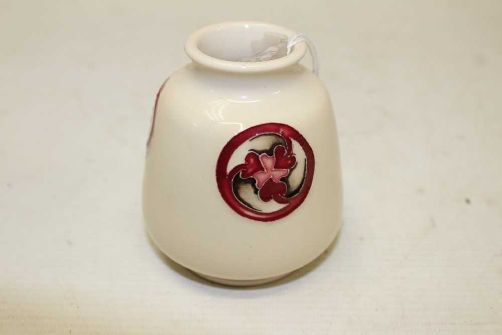Lot 2010 - Moorcroft small vase with red floral roundel decoration on cream ground, 8cm